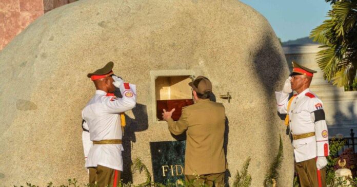 Cuba's President Raul Castro places the box containing the ashes of Cuba's former President Fidel Castro into a boulder at the Santa Ifigenia Cemetery, in Santiago de Cuba